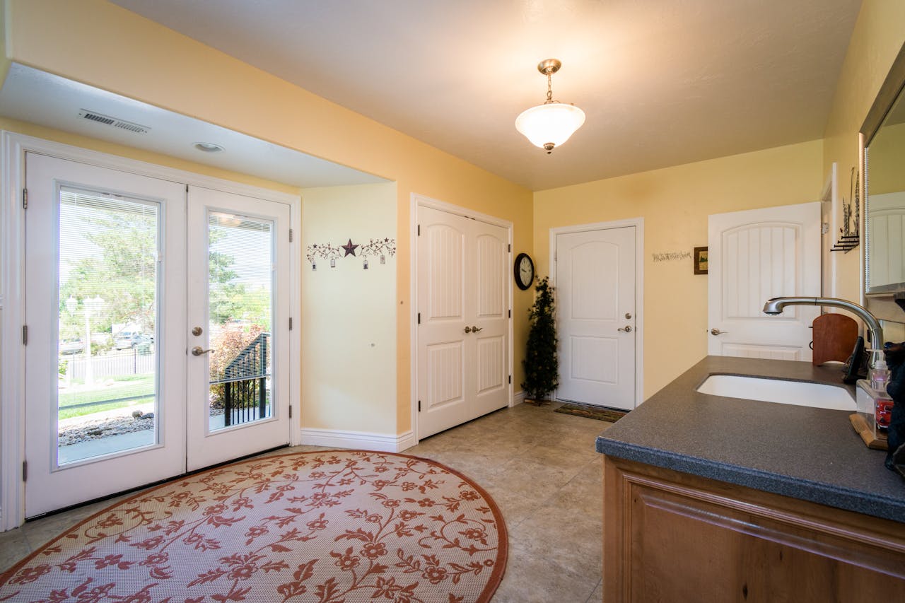 our-services-2 Spacious and bright entryway featuring a decorative rug and glass doors.